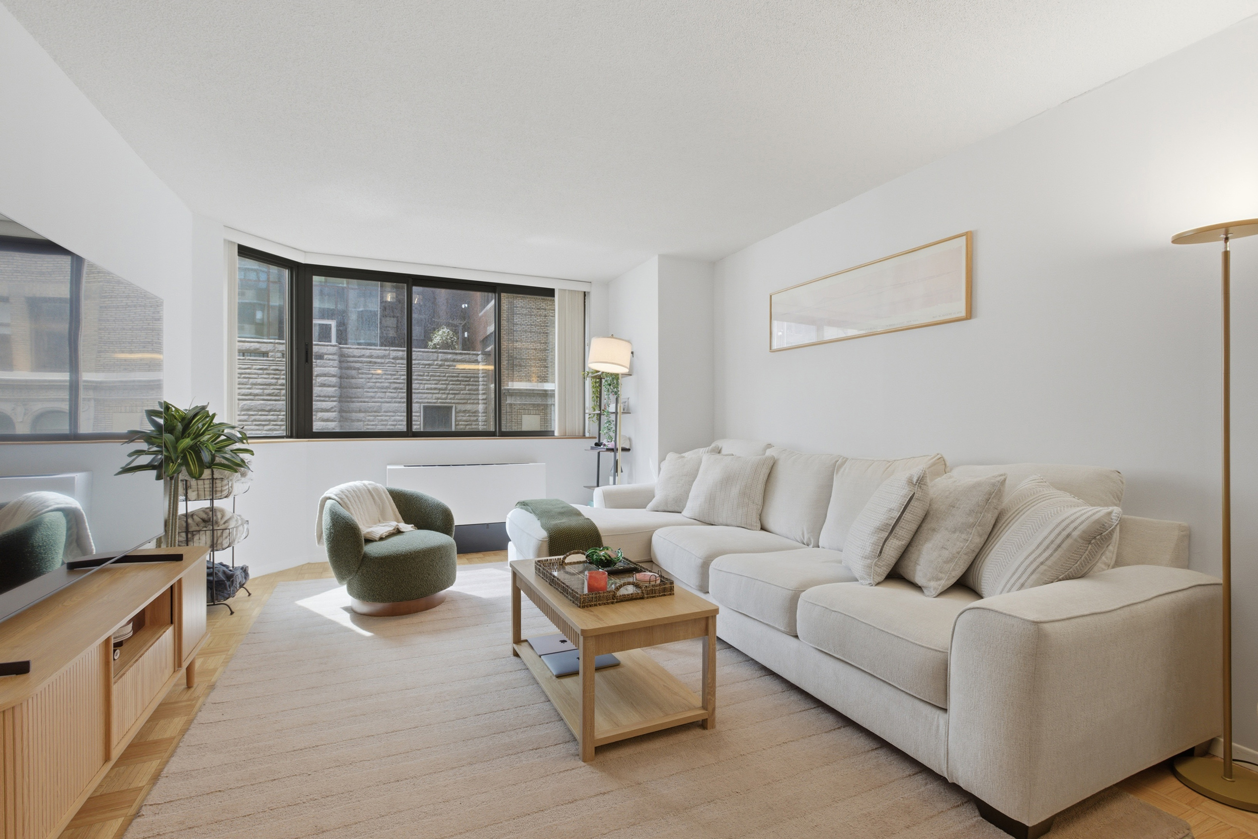 280 Park Avenue South, Unit 5L Manhattan, NY 10010 - Photo 2 of 17 a living room with furniture and a potted plant