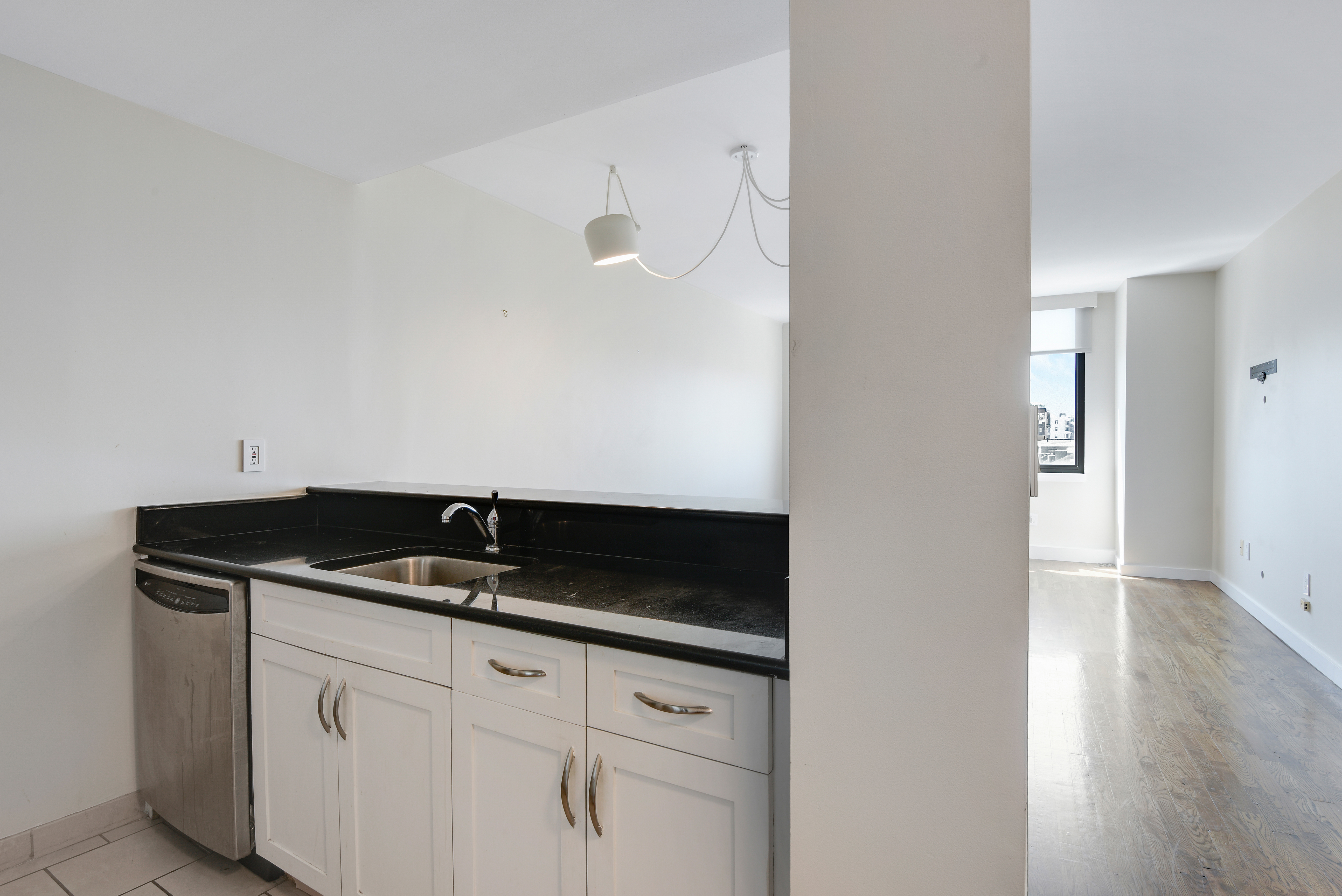 199 Bowery, Unit 11F Manhattan, NY 10002 - Photo 5 of 13 a close view of a sink and dishwasher with kitchen island