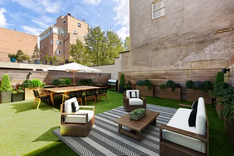 a view of yard from deck with patio