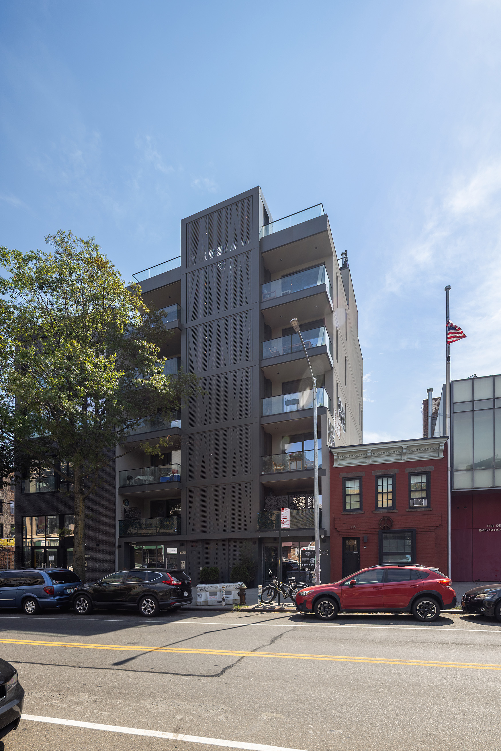 340 Metropolitan Avenue, Unit PHB Brooklyn, NY 11211 - Photo 17 of 18 a view of a tall building next to a road