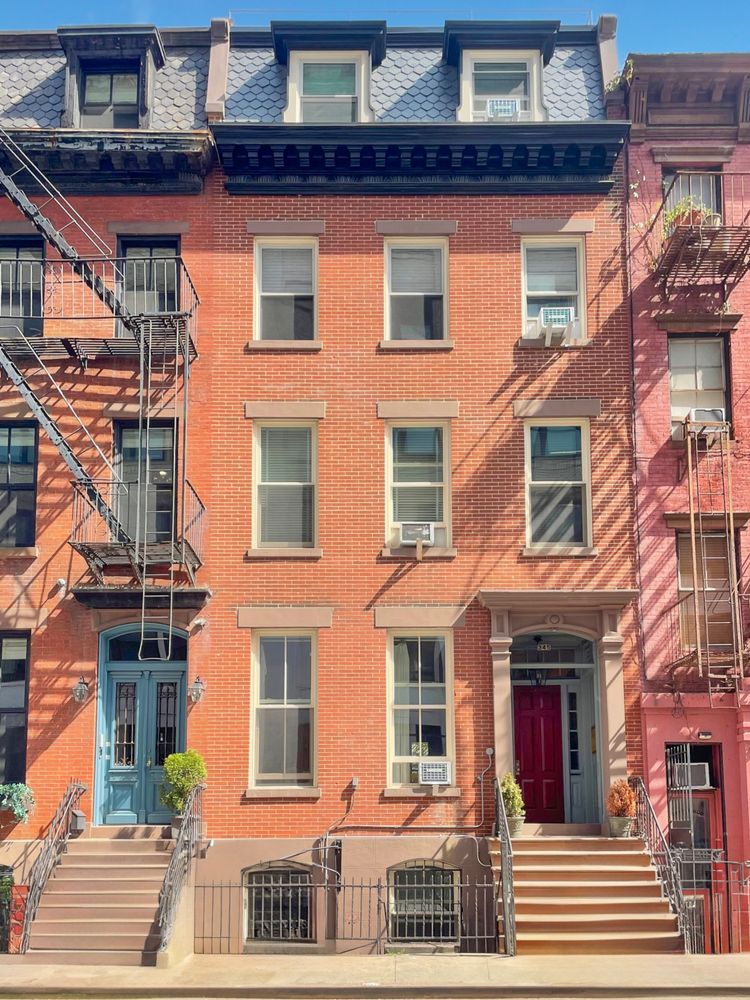 a front view of a residential apartment building with a yard