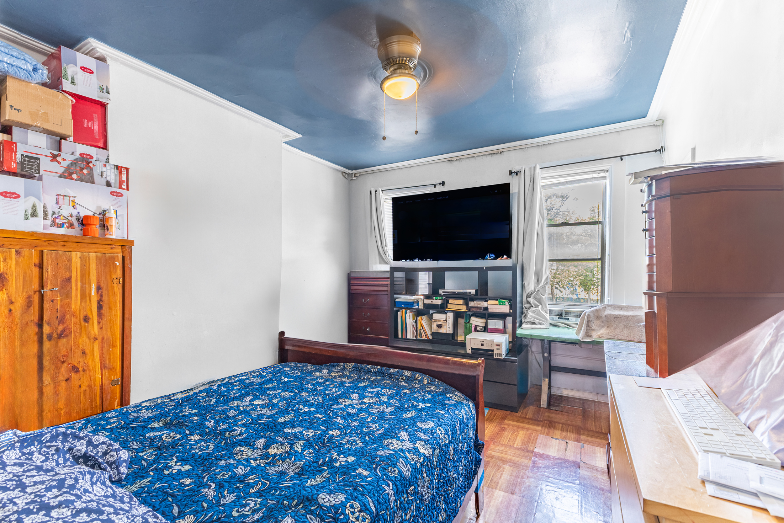 949 4th Avenue Brooklyn, NY 11232 - Photo 8 of 21 a bedroom with a bed and a flat screen tv