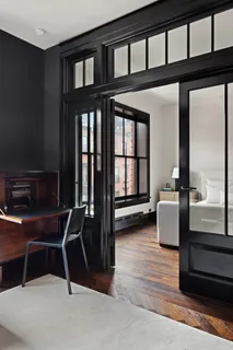 a dining room with furniture and wooden floor