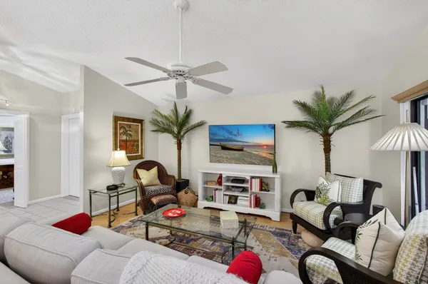 a living room with furniture a chandelier and a flat screen tv