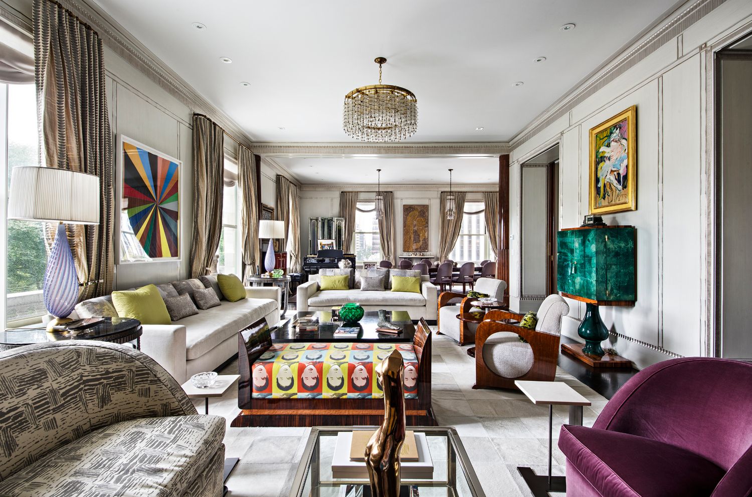a living room with furniture fireplace and a large window