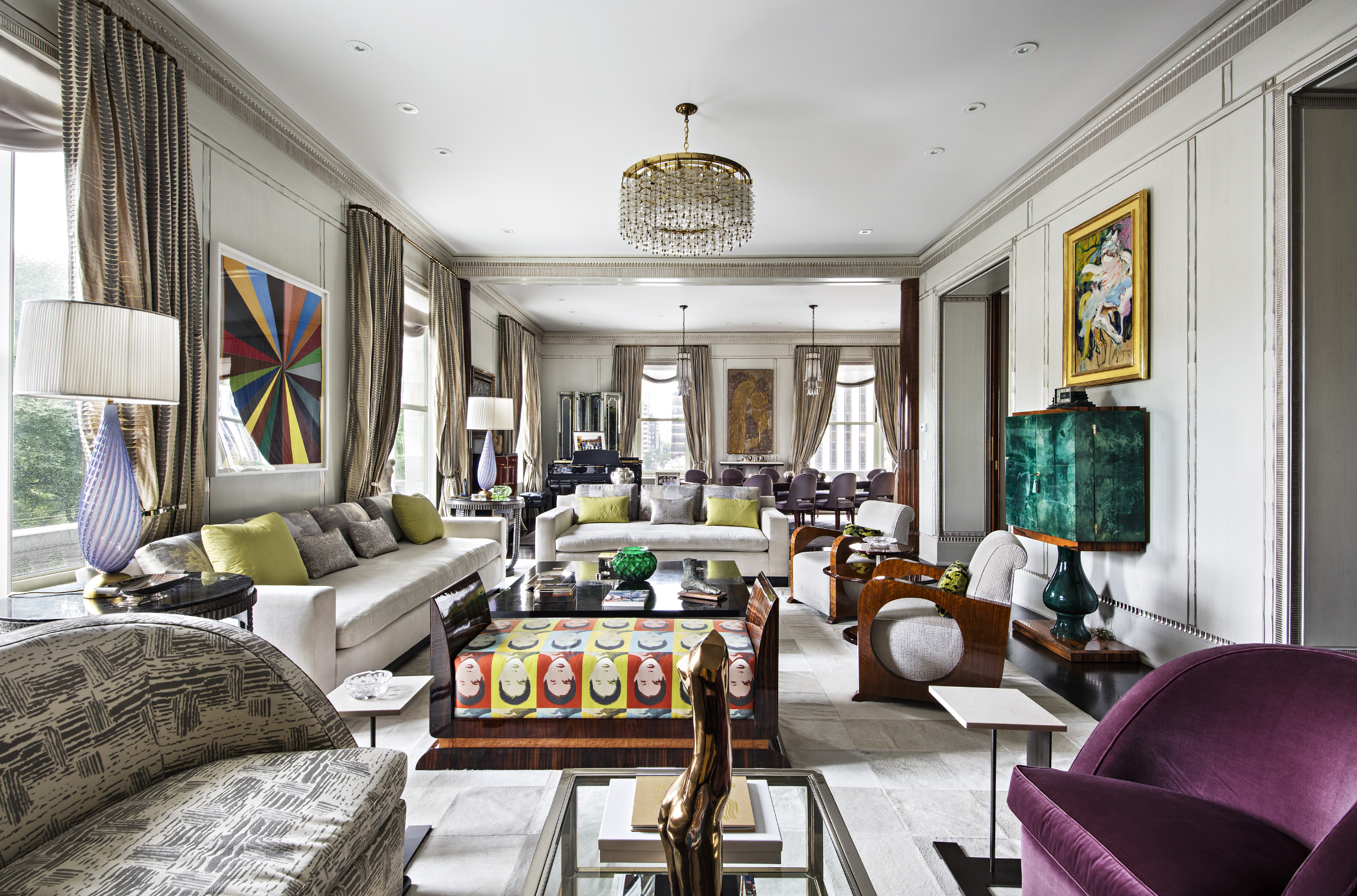 a living room with furniture fireplace and a large window