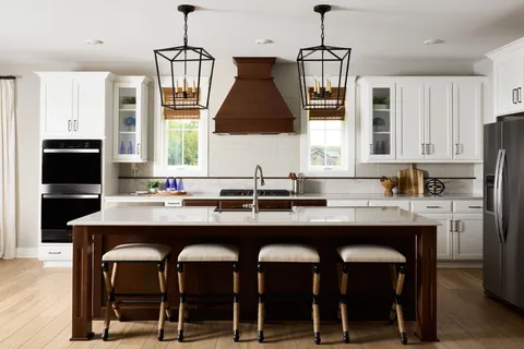 a kitchen with a sink a center island and cabinets