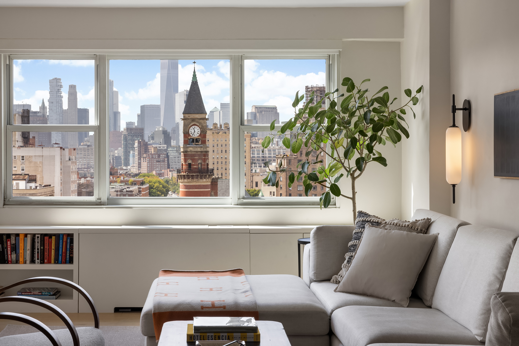 101 West 12th Street, Unit 12R Manhattan, NY 10011 - Photo 2 of 21 a living room with furniture and a potted plant