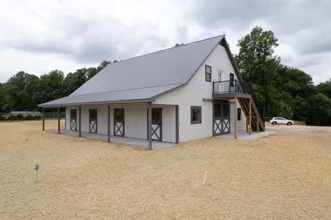 an aerial view of a residential houses with outdoor space