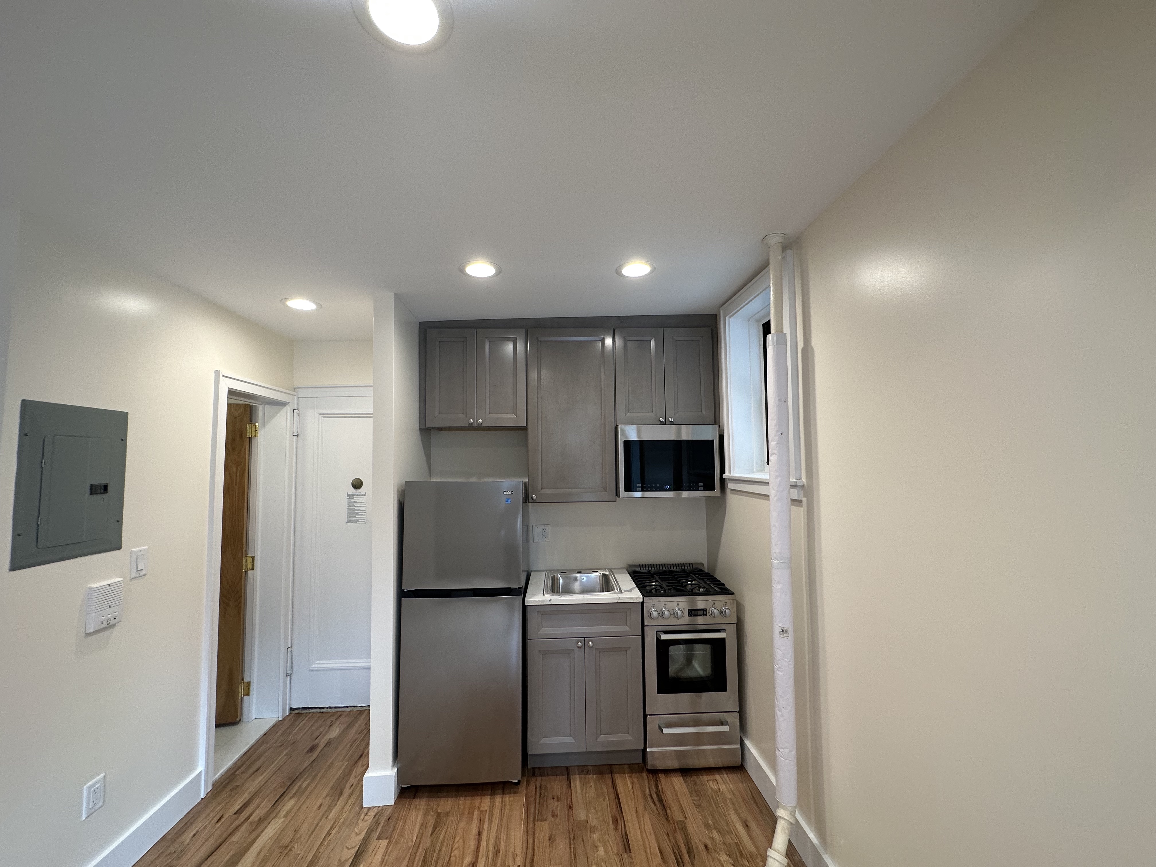 752 Greenwich Street, Unit 1A/B Manhattan, NY 10014 - Photo 4 of 12 a kitchen with stainless steel appliances granite countertop a refrigerator and a stove top oven