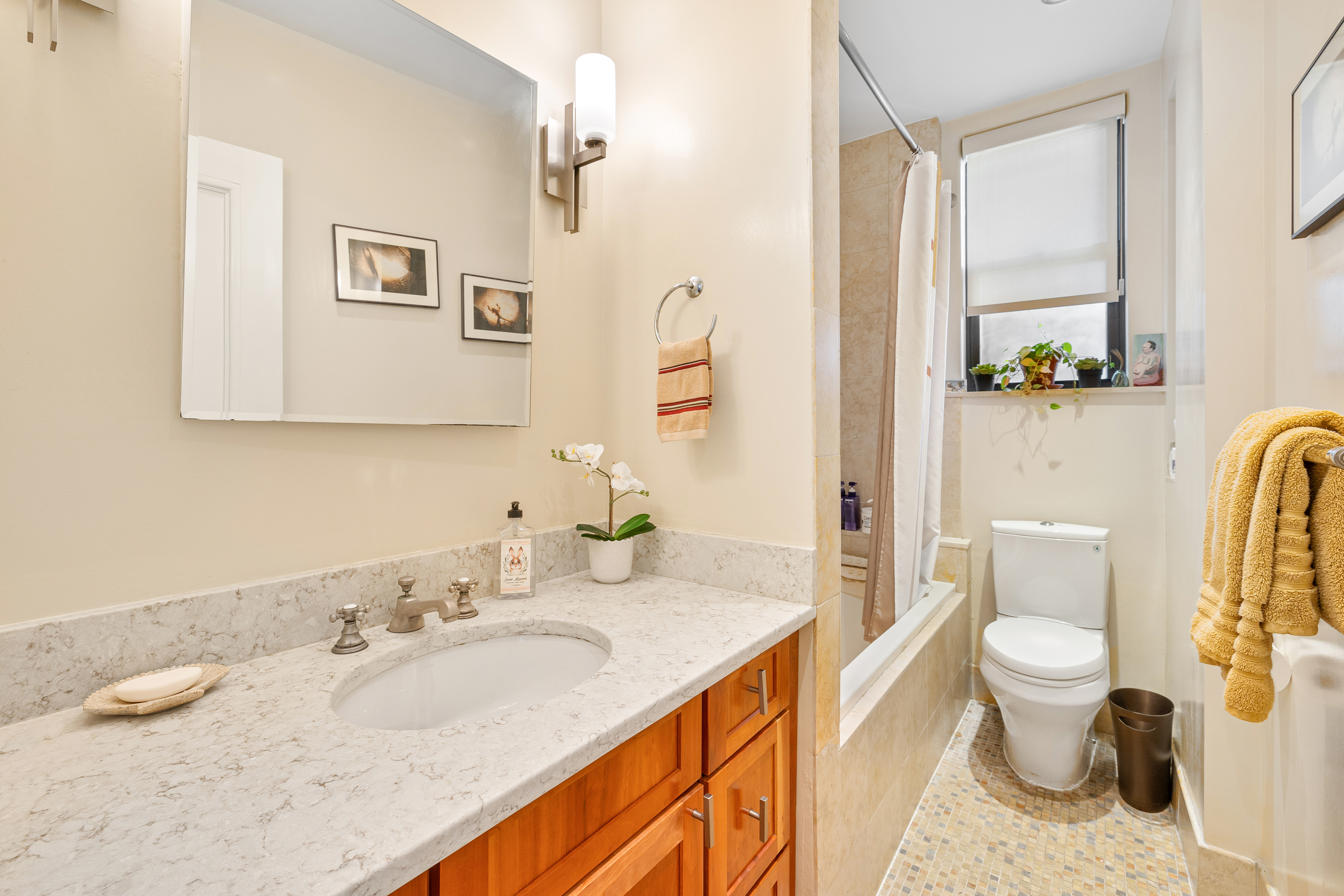 200 West 54th Street, Unit 9G Manhattan, NY 10019 - Photo 12 of 17 a bathroom with a granite countertop sink mirror vanity and toilet