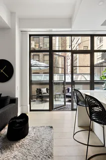 a living room with furniture and a floor to ceiling window