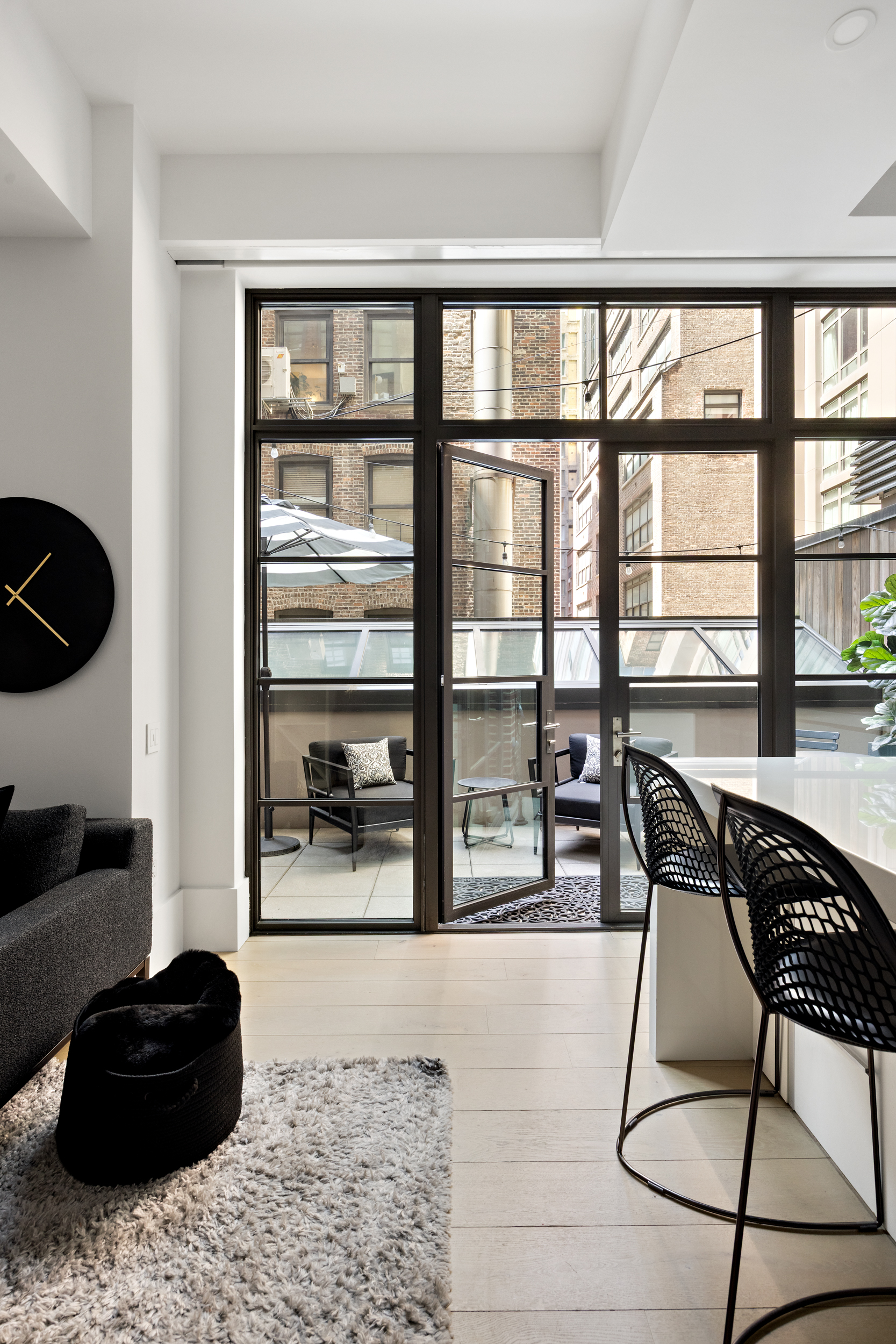 404 Park Avenue South, Unit 3E Manhattan, NY 10016 - Photo 2 of 21 a living room with furniture and a floor to ceiling window