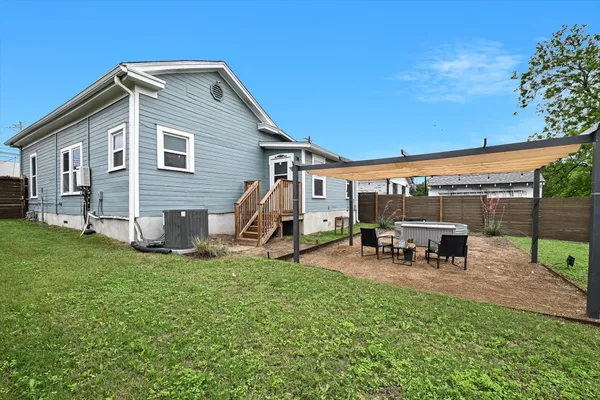 a view of a house with a yard and sitting area
