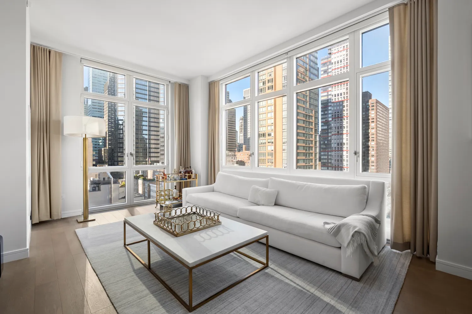 a living room with furniture and large windows