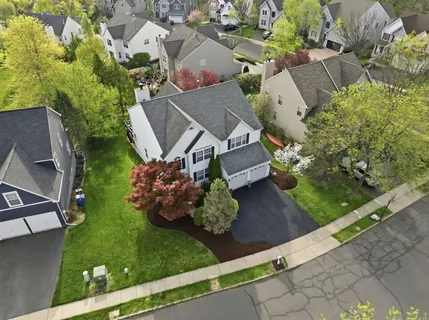 an aerial view of a house with garden space and street view