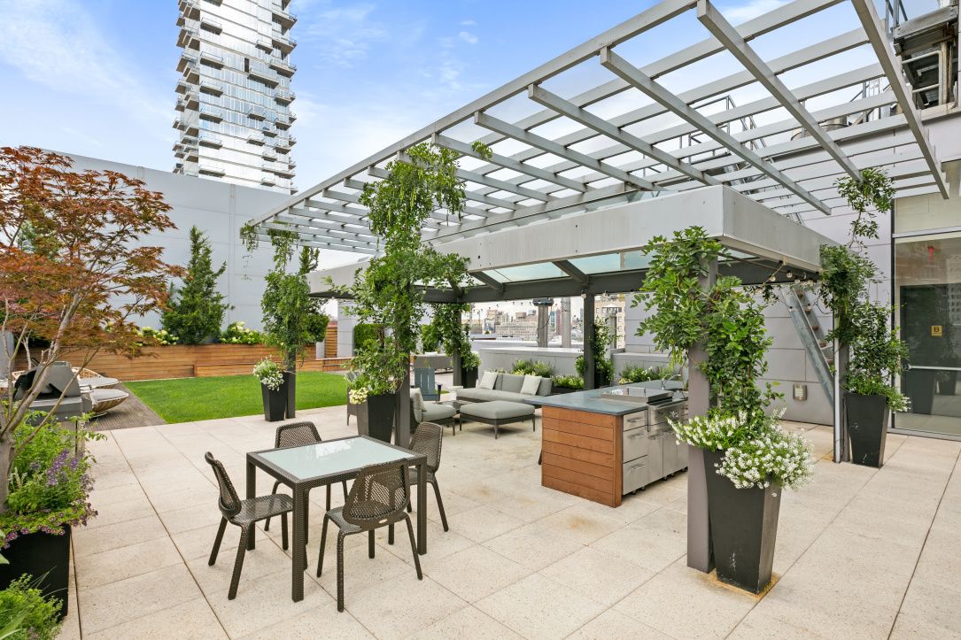 a view of a patio with a table and chairs and potted plants