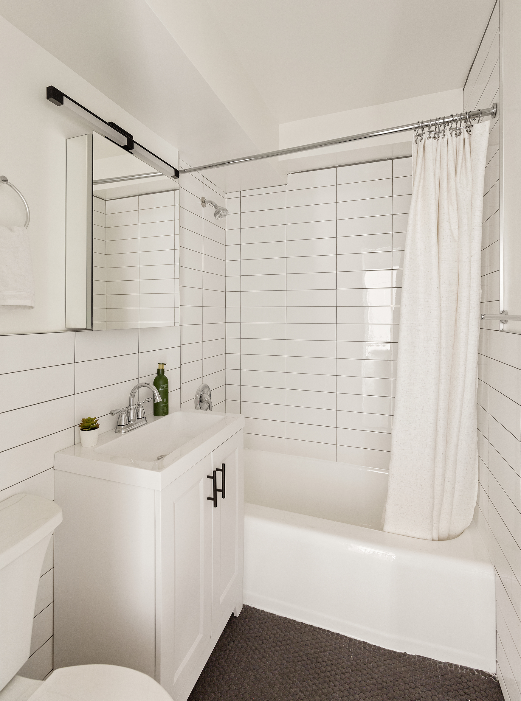 411 East 53rd Street, Unit 6L Manhattan, NY 10022 - Photo 11 of 12 a bathroom with a sink a toilet and shower