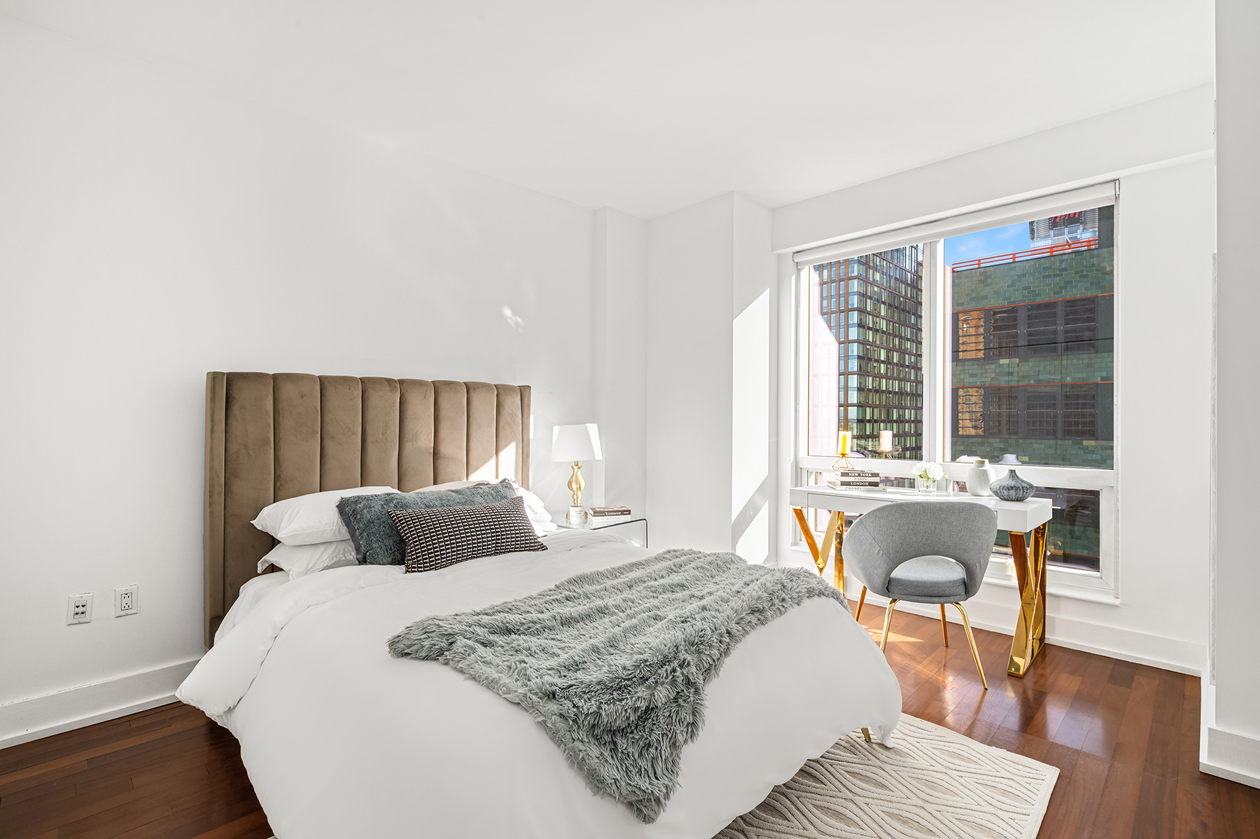 350 West 42nd Street, Unit 20G Manhattan, NY 10036 - Photo 4 of 27 a bedroom with a bed and a large window