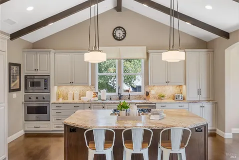 a kitchen with a dining table and chairs