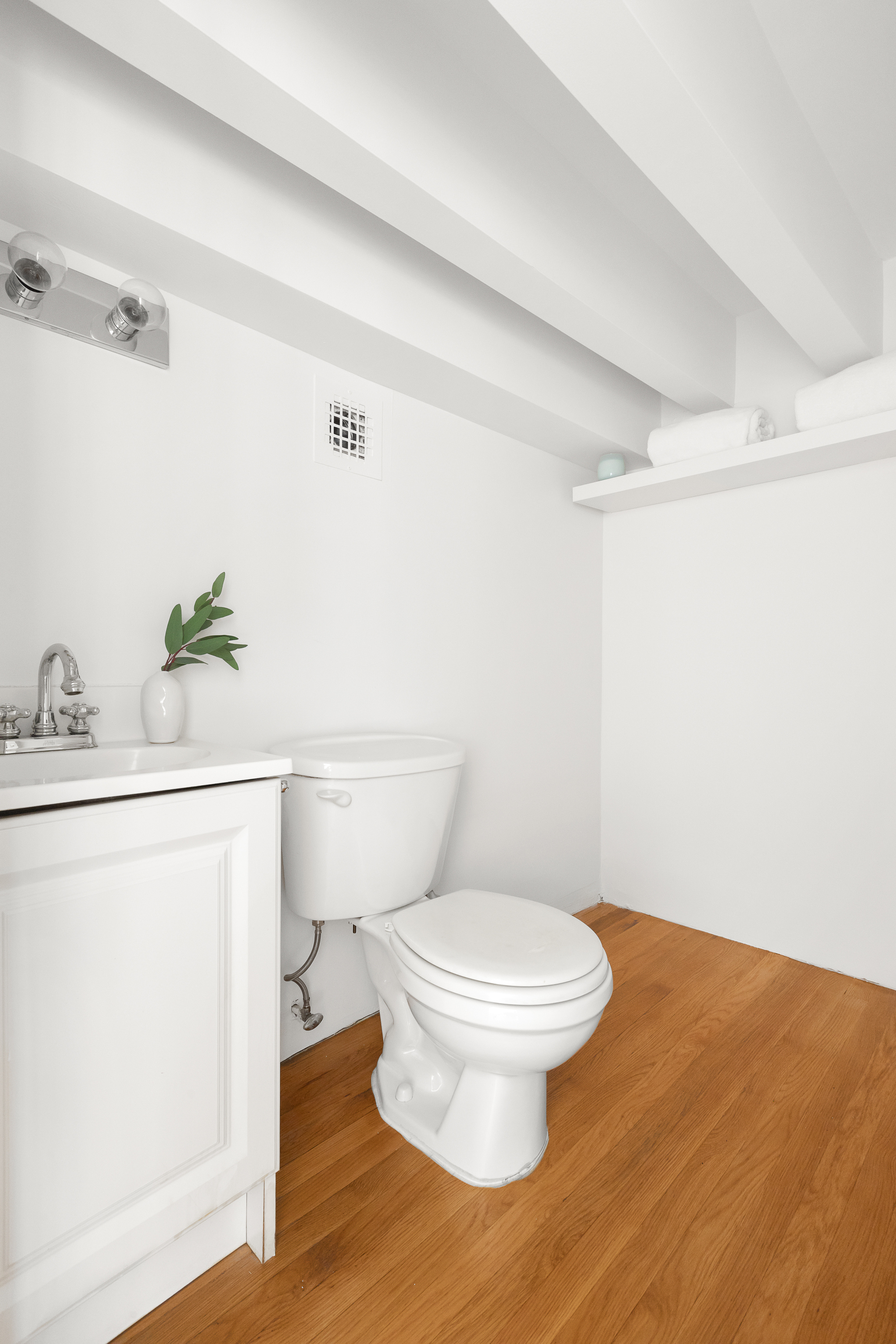 250 Mercer Street, Unit C415 Manhattan, NY 10012 - Photo 10 of 11 a white toilet sitting next to a bathroom sink