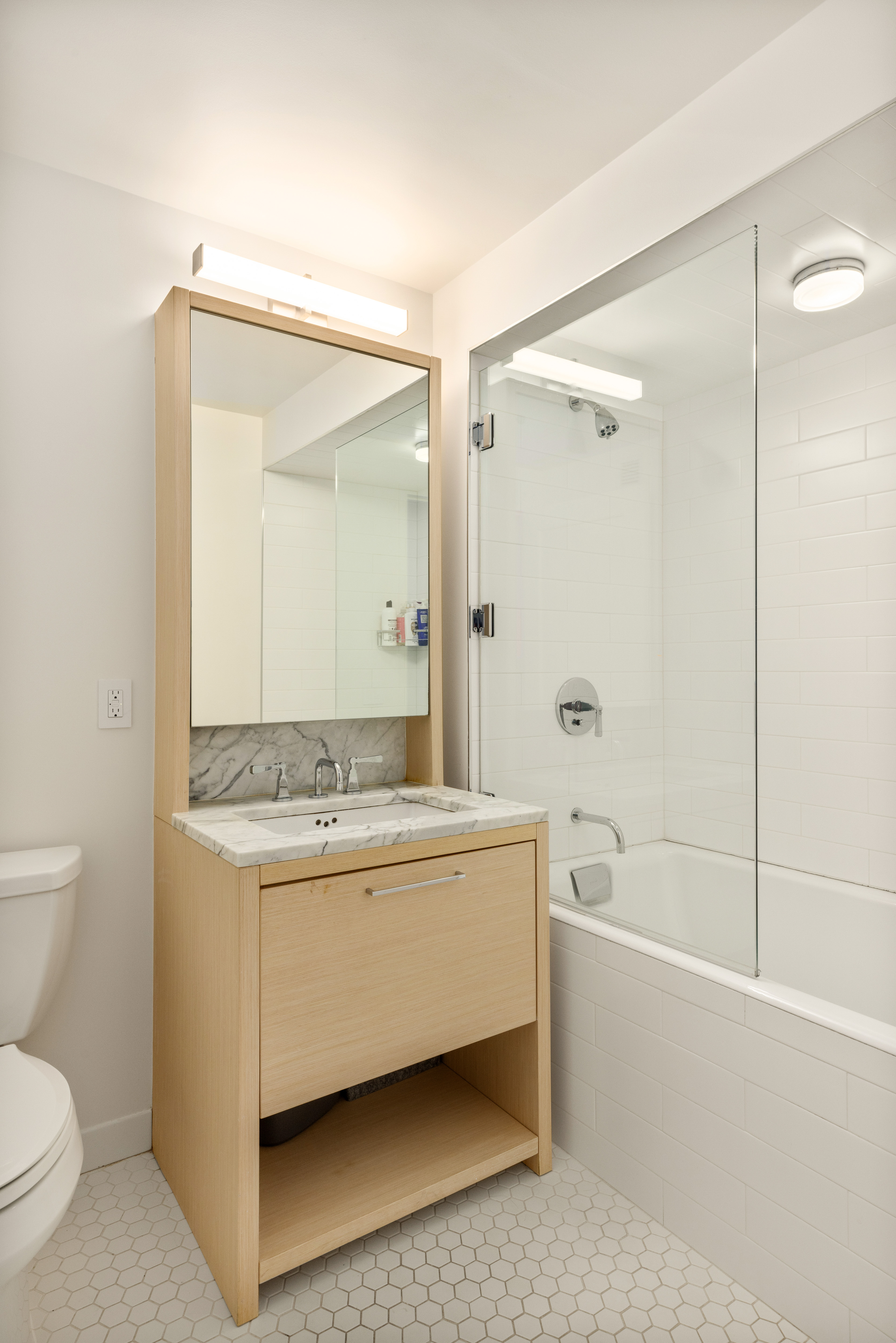 101 West 87th Street, Unit 415 Manhattan, NY 10024 - Photo 9 of 10 a bathroom with a granite countertop sink a toilet and shower