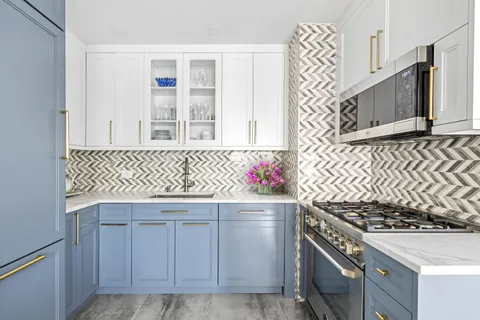 a kitchen with granite countertop cabinets and stove