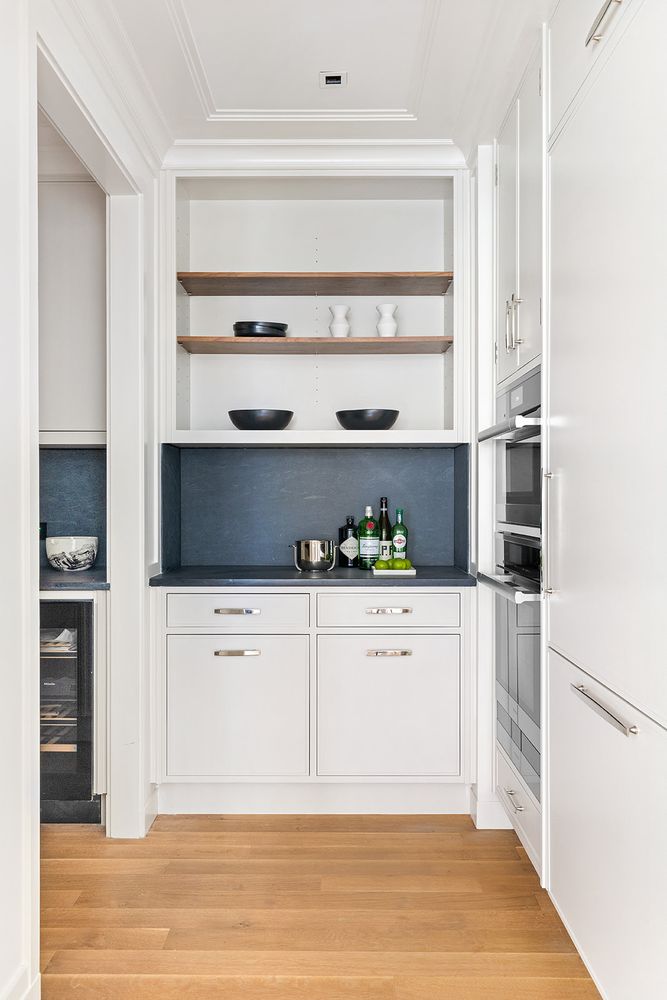 a kitchen with stainless steel appliances white cabinets and a window
