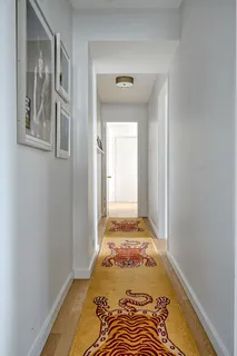 a view of a bedroom with wooden floor and bathroom