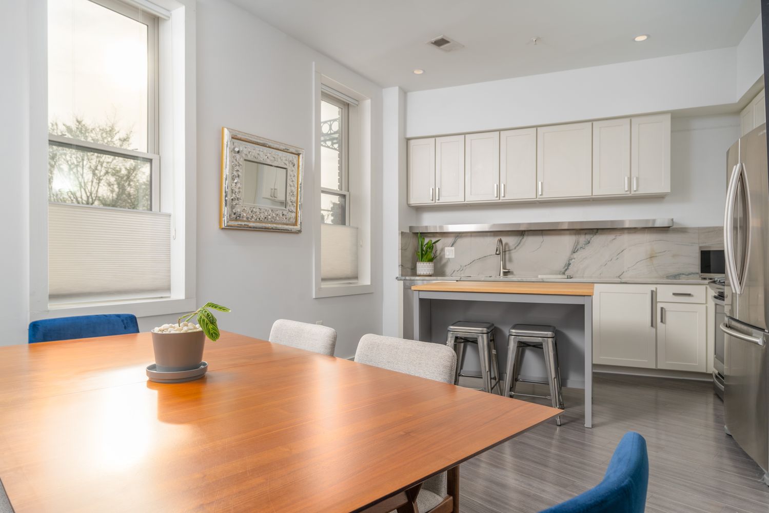 a kitchen with a table chairs and a refrigerator
