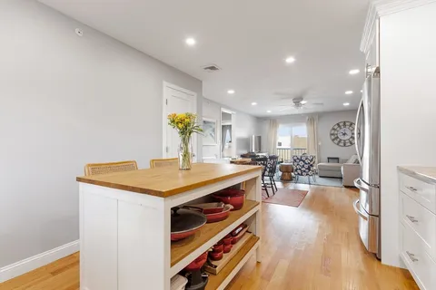 a view of a kitchen area with furniture and wooden floor