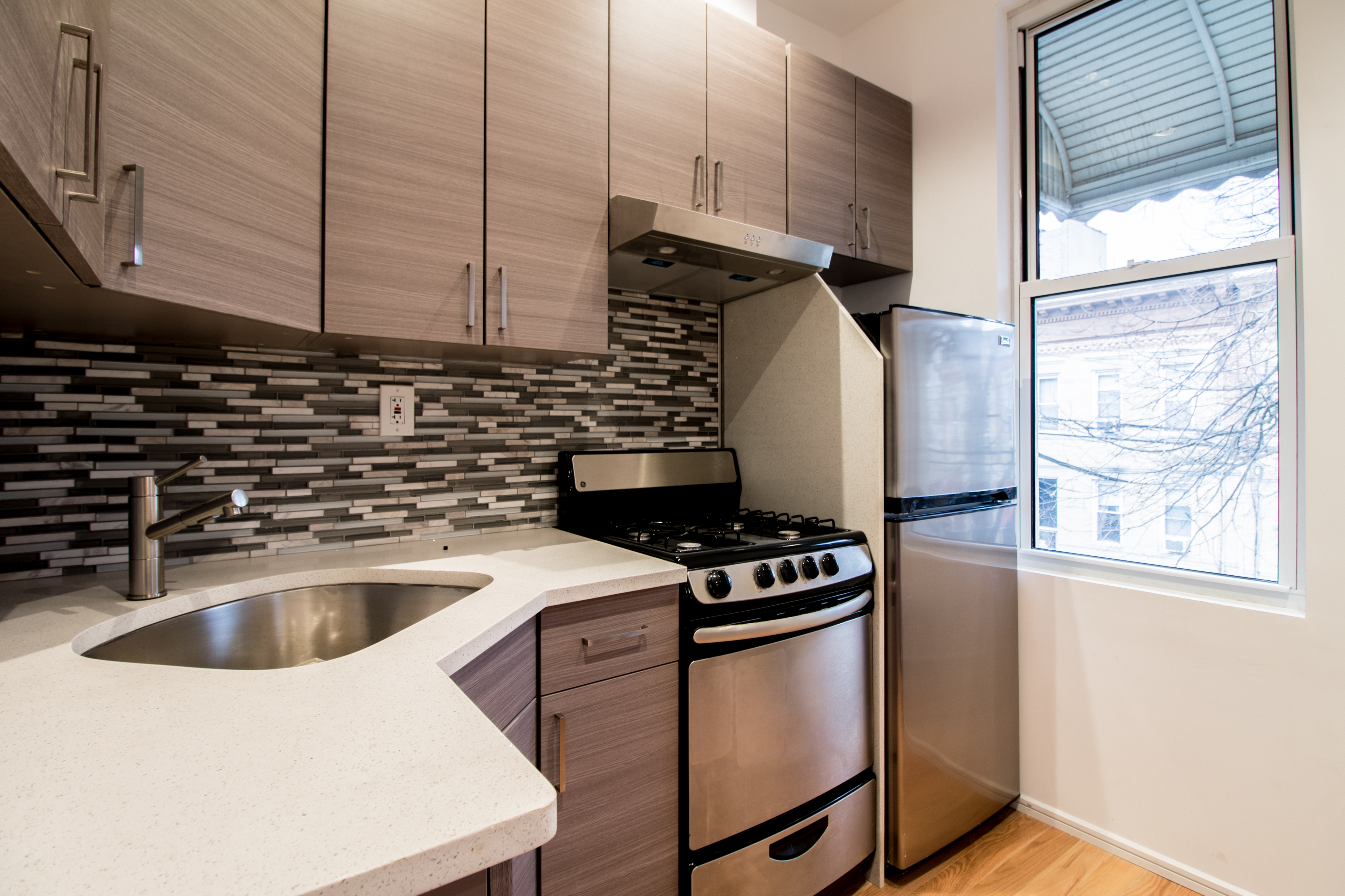 1923 Cornelia Street, Unit 2F Queens, NY 11385 - Photo 6 of 9 a kitchen that has a sink and a stove