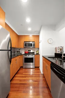 a kitchen with stainless steel appliances and wooden cabinets