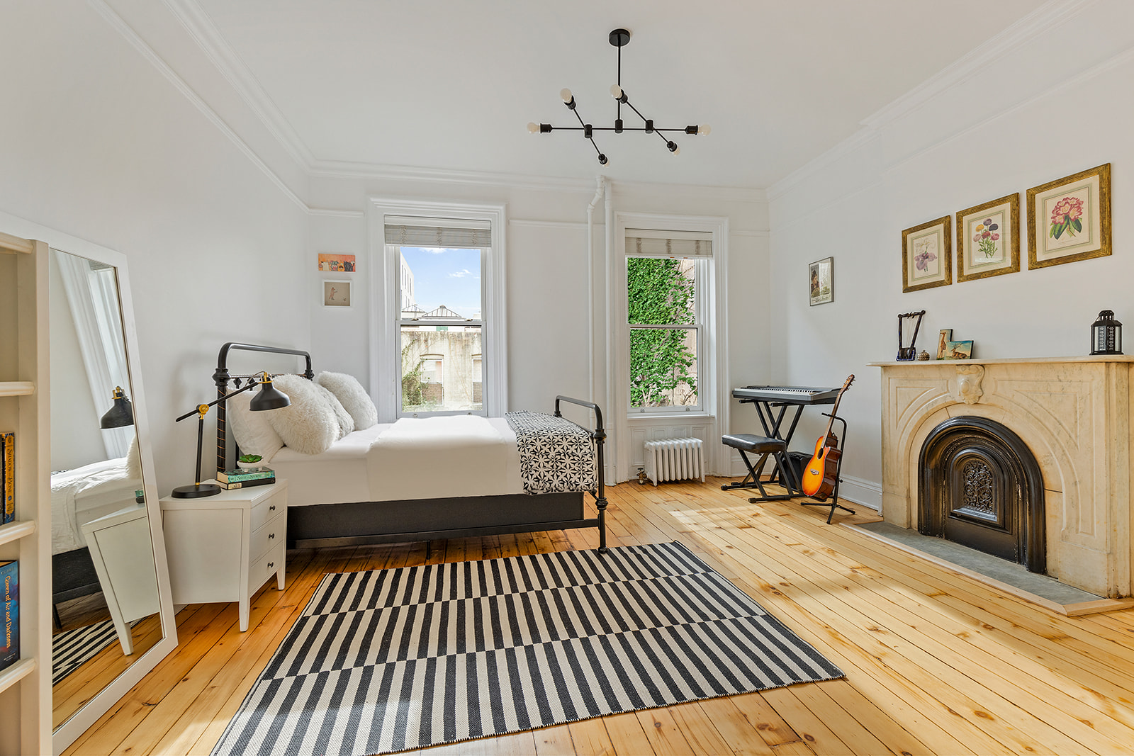 146 Berkeley Place Brooklyn, NY 11217 - Photo 5 of 21 a bedroom with a bed and a chandelier