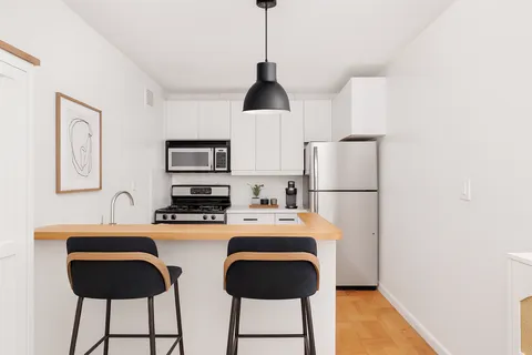 a kitchen with stainless steel appliances a sink and a refrigerator