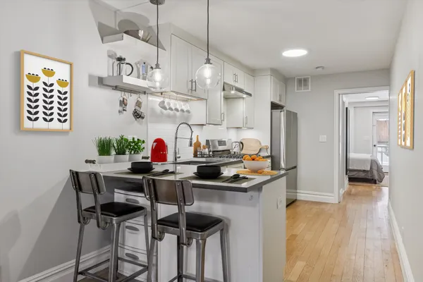 a kitchen with stainless steel appliances granite countertop a sink and a refrigerator