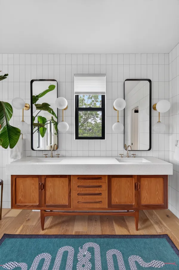 a bathroom with mirror and window