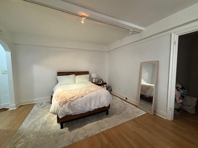 319 East 50th Street, Unit 10L Manhattan, NY 10022 - Photo 2 of 11 a bedroom with a bed and a flat tv screen on a dresser