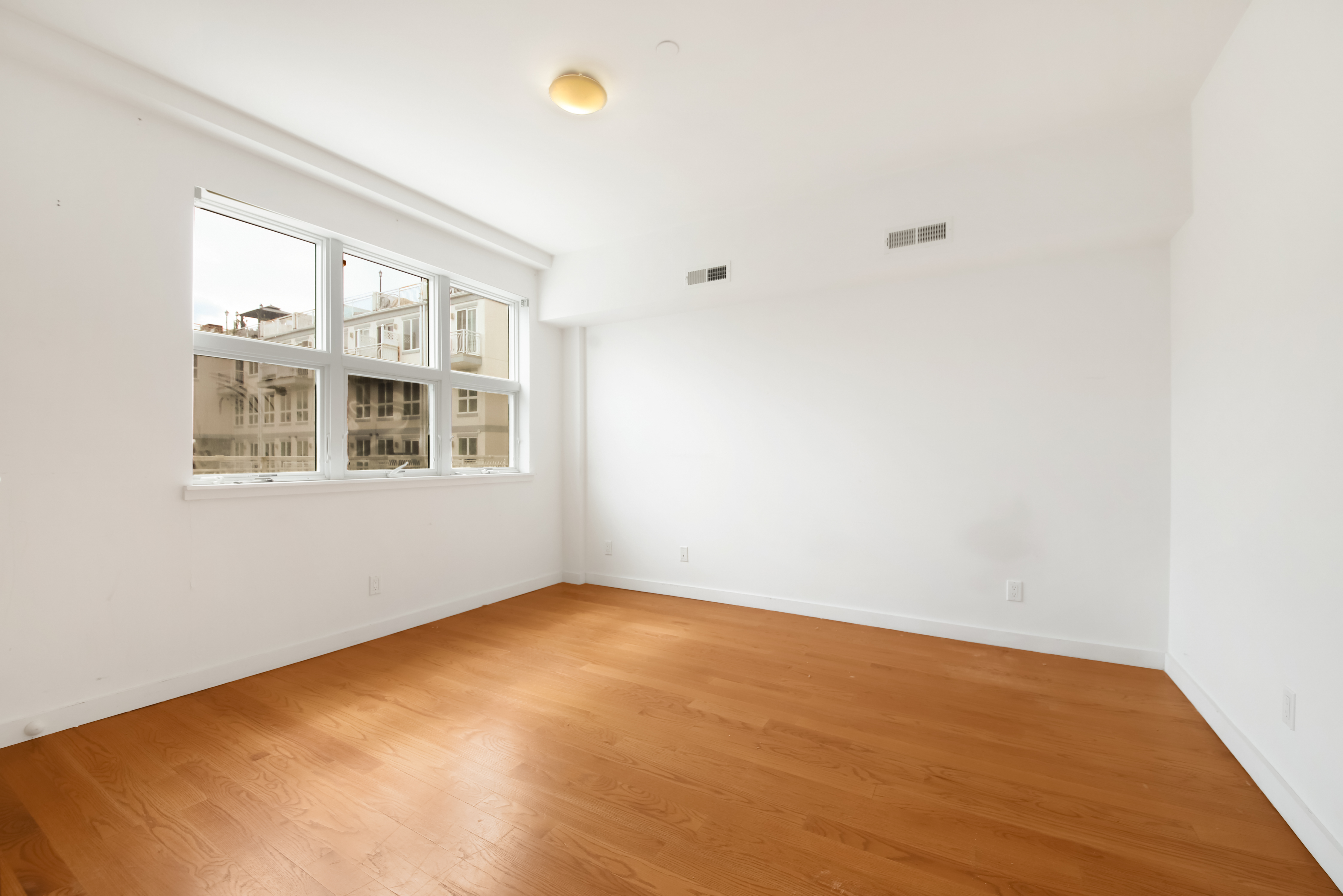 3112 Emmons Avenue, Unit 107 Brooklyn, NY 11235 - Photo 9 of 14 a view of an empty room with a window