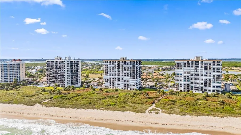 a kitchen with stainless steel appliances granite countertop a refrigerator a stove top oven a sink and cabinets