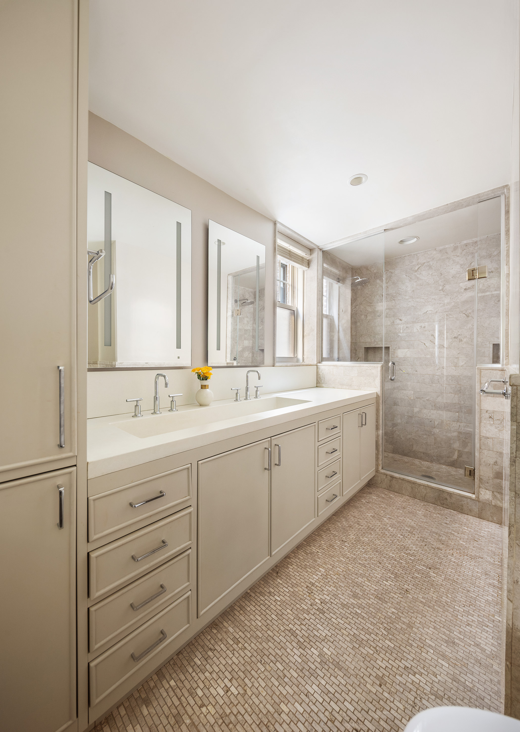 450 West End Avenue, Unit 3B Manhattan, NY 10024 - Photo 7 of 13 a spacious bathroom with a double vanity sink a mirror and a shower