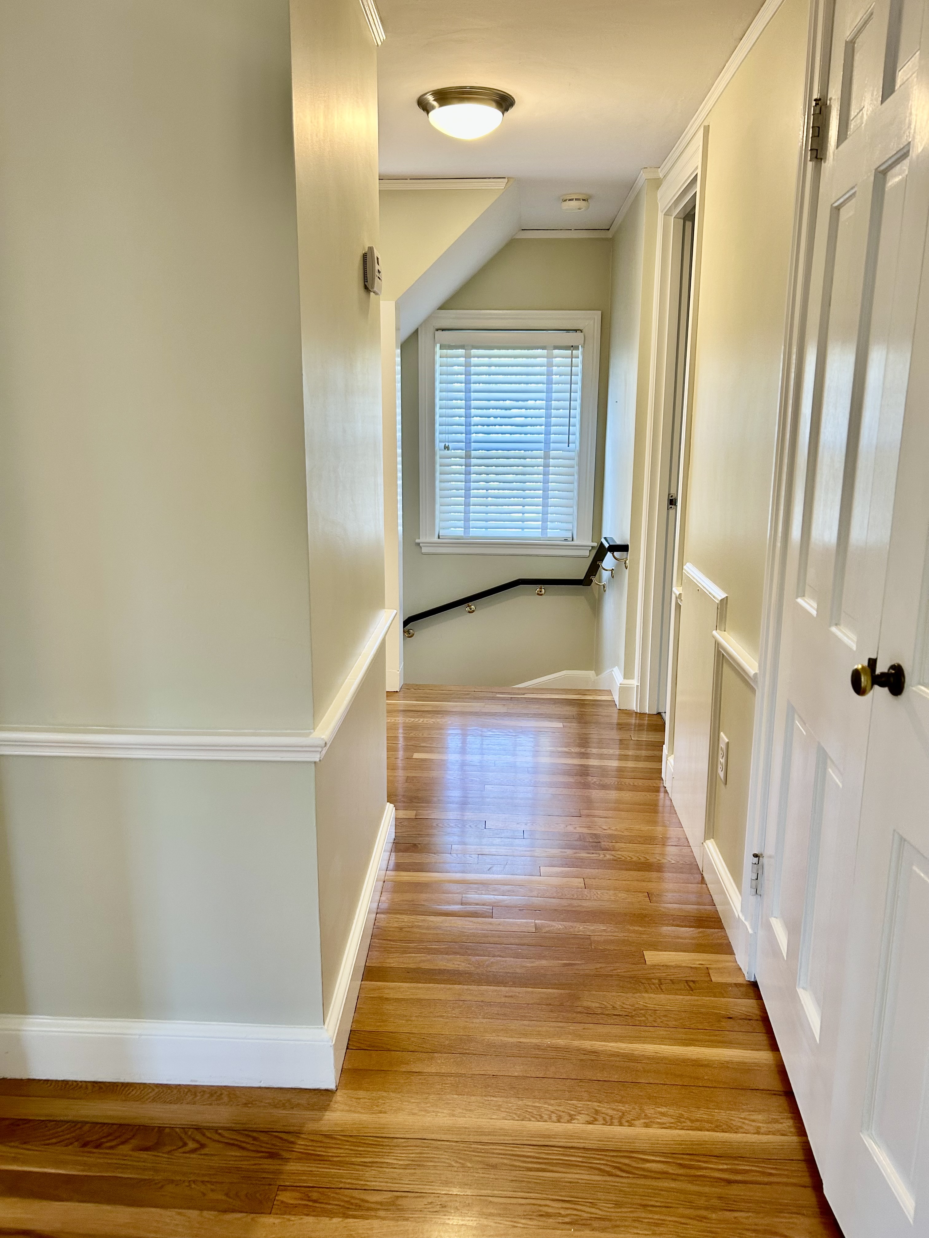 142 Tower Road Lincoln, MA 01773 - Photo 17 of 31 a view of a hallway with wooden floor and staircase
