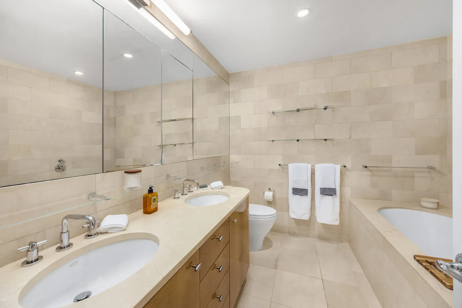 a bathroom with a sink a toilet and mirror