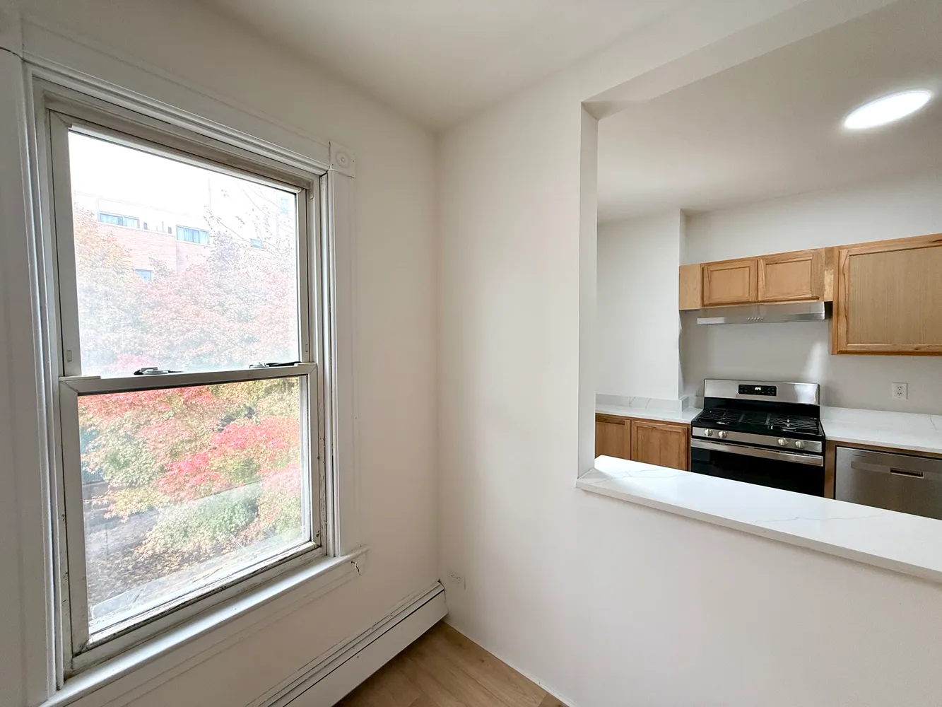 a kitchen with stainless steel appliances a stove and a window