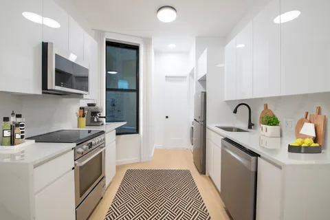 a kitchen with stainless steel appliances granite countertop a sink and stove top oven
