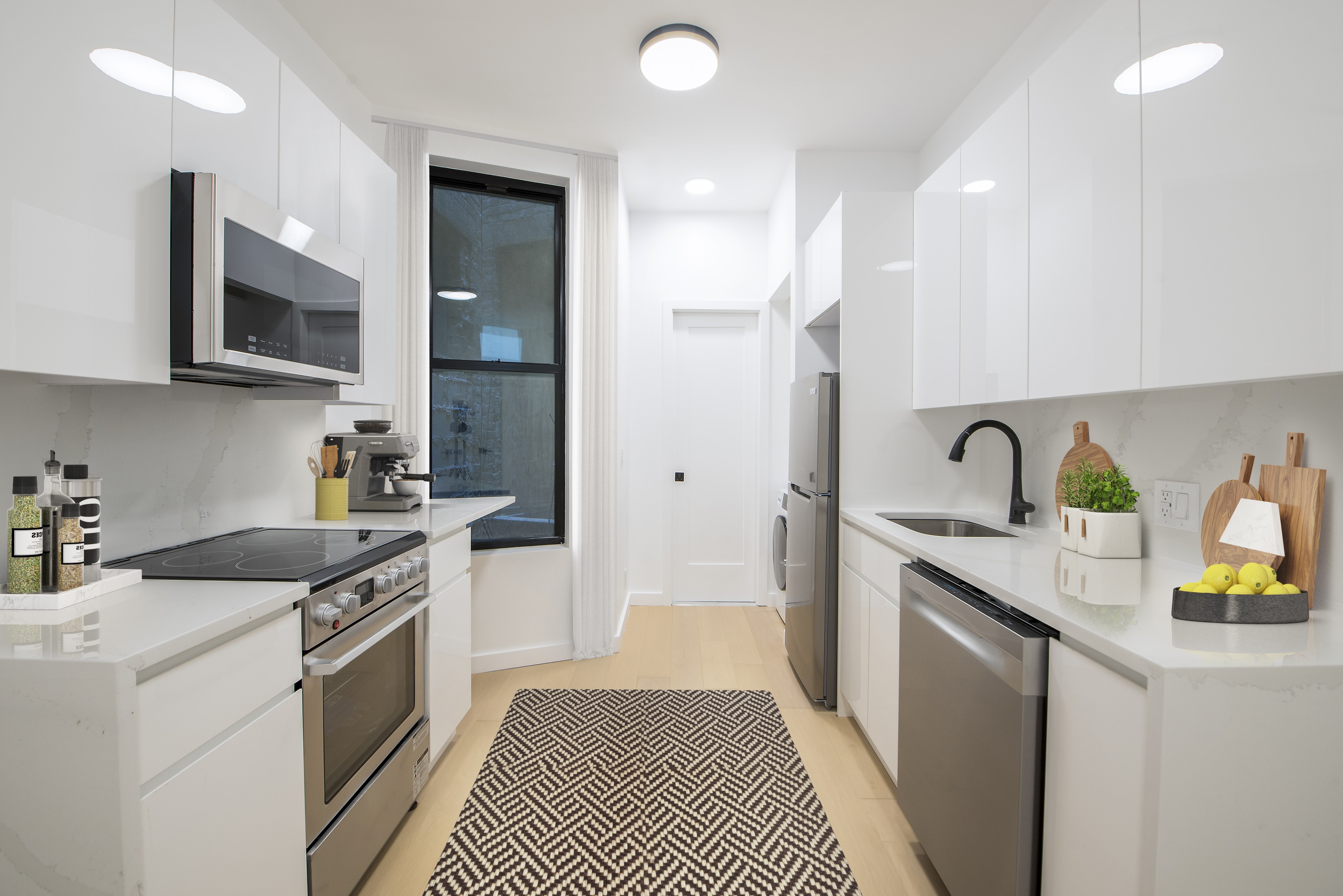 433 Wythe Avenue, Unit 4A Brooklyn, NY 11249 - Photo 2 of 5 a kitchen with stainless steel appliances granite countertop a sink and stove top oven