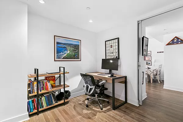 425 East 13th Street, Unit 2A Manhattan, NY 10009 - Photo 4 of 7 a view of a workspace with furniture and wooden floor