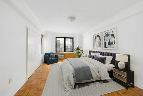 a bedroom with a large bed and a window