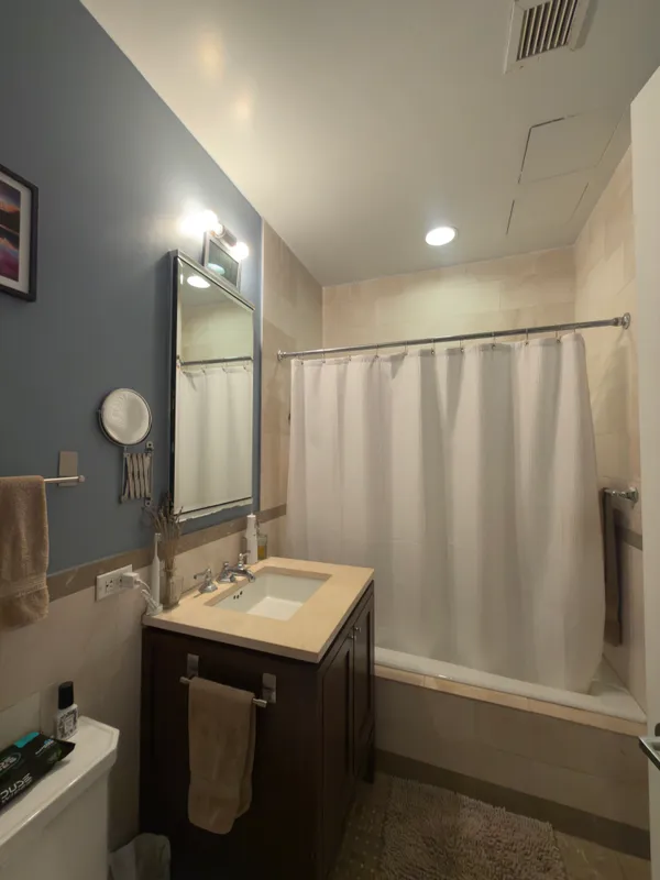 a bathroom with a sink a mirror and a shower