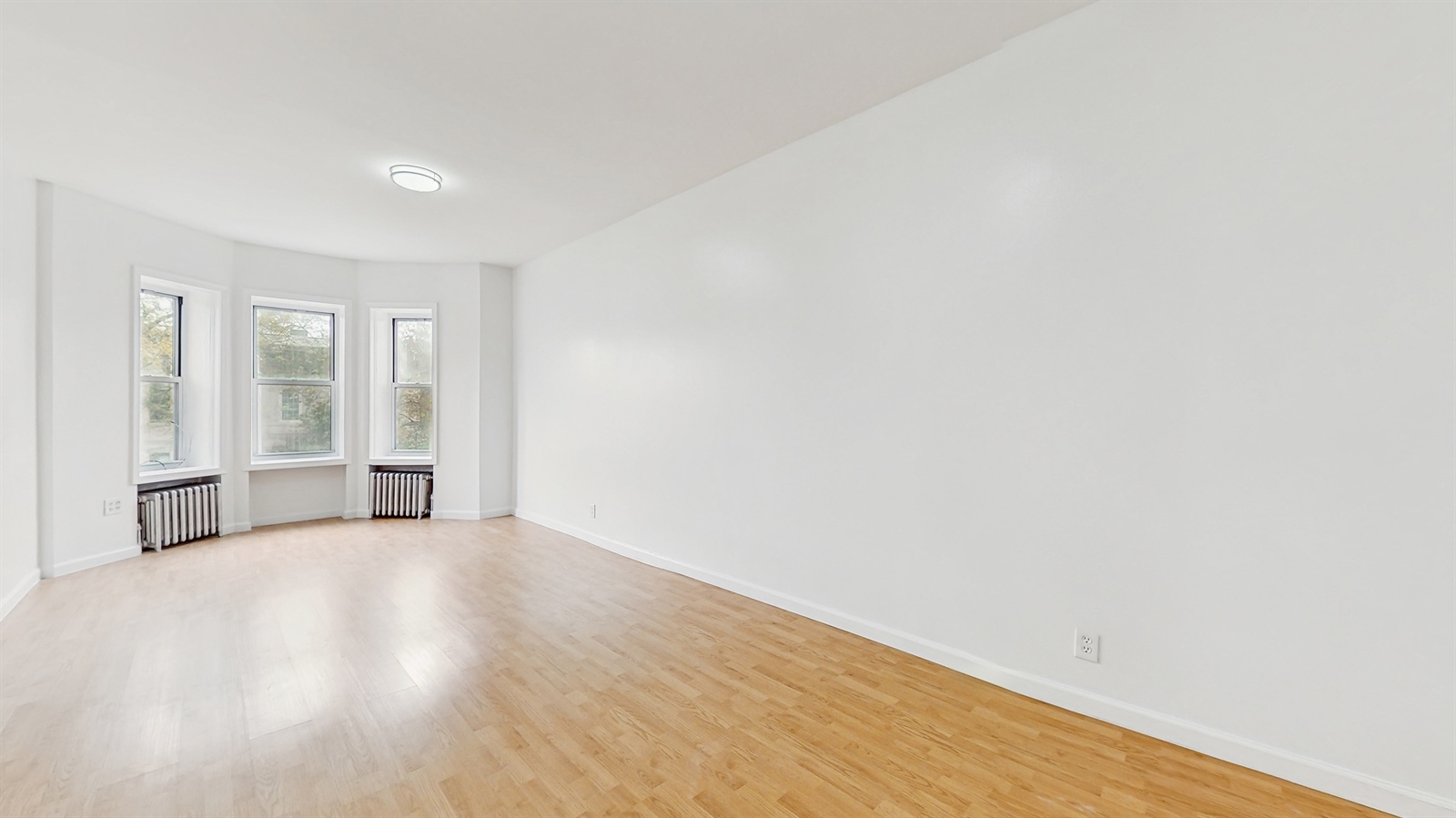 454 77th Street, Unit 3 Brooklyn, NY 11209 - Photo 8 of 25 a view of an empty room with wooden floor